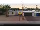 Inviting single-story home boasts desert landscaping, a brick driveway and desert mountain views at sunset at 3615 E Charter Oak Rd, Phoenix, AZ 85032