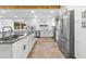 Gourmet kitchen with stainless steel appliances, white cabinetry, and a large island at 3615 E Charter Oak Rd, Phoenix, AZ 85032