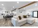 Open-concept living space with white sofa, dining area, and modern kitchen at 3615 E Charter Oak Rd, Phoenix, AZ 85032