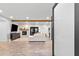 Spacious living room features a stone fireplace, modern furniture, and wood-look tile flooring at 3615 E Charter Oak Rd, Phoenix, AZ 85032