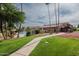 Well-maintained community grounds with a pool, mature trees, and walking path at 3825 E Camelback Rd # 117, Phoenix, AZ 85018