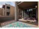 Private patio with a table, chairs, and a colorful rug, perfect for outdoor relaxation at 3825 E Camelback Rd # 117, Phoenix, AZ 85018