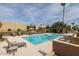 Inviting community pool area with lounge chairs and well-maintained landscaping at 3825 E Camelback Rd # 117, Phoenix, AZ 85018