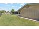 Backyard featuring lush green grass and an enclosed porch with window screens at 400 N Jay N St, Chandler, AZ 85225