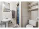 Small bathroom has white tile, pedestal sink, toilet, and shower with curtain at 400 N Jay N St, Chandler, AZ 85225