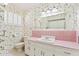 Charming bathroom with floral wallpaper, a classic vanity with a pink countertop, and a large mirror at 400 N Jay N St, Chandler, AZ 85225