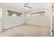 Light-filled bedroom with neutral carpet, ceiling fan, and two windows with shades at 400 N Jay N St, Chandler, AZ 85225