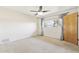 Bright bedroom featuring neutral carpet, a ceiling fan, and a large window for natural light at 400 N Jay N St, Chandler, AZ 85225