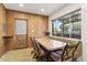 Cozy dining area with wood paneled walls and backyard view through a large window at 400 N Jay N St, Chandler, AZ 85225