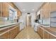 Bright kitchen featuring a window over the sink, white appliances and custom cabinets at 400 N Jay N St, Chandler, AZ 85225