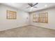 Bright living room features two windows with wooden blinds and vinyl floors at 400 N Jay N St, Chandler, AZ 85225
