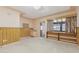 Versatile room with wood-paneled walls, built-in shelves, and access to another room, offering flexible use at 400 N Jay N St, Chandler, AZ 85225