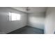 Empty bedroom with a ceiling fan, window, and carpeted floor at 4008 W El Caminito Dr, Phoenix, AZ 85051