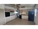 An open kitchen with lots of cabinets and a refrigerator at 4008 W El Caminito Dr, Phoenix, AZ 85051