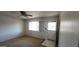 Bright living room with a ceiling fan, window, and carpeted floor at 4008 W El Caminito Dr, Phoenix, AZ 85051