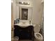 Bathroom with an updated vanity, decorative mirror, and standard toilet featuring basic finishes at 4614 N 19 Ave, Phoenix, AZ 85015