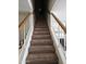 Carpeted staircase featuring a white-painted wood banister and railing leading upstairs at 4614 N 19 Ave, Phoenix, AZ 85015