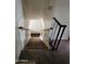 A carpeted staircase with wooden and metal railings, ascending to the upper level of the home at 4614 N 19 Ave, Phoenix, AZ 85015