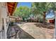Relaxing backyard with a covered patio, mature trees, and a well-maintained garden area at 4808 W Shaw Butte Dr, Glendale, AZ 85304