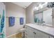 Bright bathroom featuring a white vanity with modern lighting and decorative shower curtain at 4808 W Shaw Butte Dr, Glendale, AZ 85304
