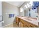 Bathroom with light wood cabinets, long counter and sink at 4808 W Shaw Butte Dr, Glendale, AZ 85304