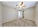 Neutral bedroom featuring plush carpeting, ceiling fan, and a closet for ample storage at 4808 W Shaw Butte Dr, Glendale, AZ 85304