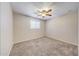 Cozy bedroom featuring neutral carpeting, a window and ceiling fan at 4808 W Shaw Butte Dr, Glendale, AZ 85304