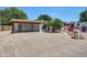 Wide view of single-story home and desert-landscaped front yard with charming curb appeal at 4808 W Shaw Butte Dr, Glendale, AZ 85304
