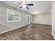 Living room with light walls, hardwood floors, ceiling fan and large window at 4808 W Shaw Butte Dr, Glendale, AZ 85304