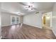 Open living room with light walls, hardwood floors, ceiling fans and glass doors to the backyard at 4808 W Shaw Butte Dr, Glendale, AZ 85304