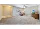 Living room with carpet, stone accent wall, ceiling fan and large window at 4808 W Shaw Butte Dr, Glendale, AZ 85304
