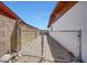 Gated side yard with gravel landscaping, providing a secure and low-maintenance outdoor space at 4808 W Shaw Butte Dr, Glendale, AZ 85304