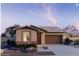 Charming single-story home featuring a stone-accented facade, low-maintenance landscaping and attached two car garage at 5633 S 253Rd Ave, Buckeye, AZ 85326
