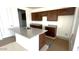 View of a kitchen with dark brown cabinets, granite countertops, and a center island sink before appliances are installed at 5633 S 253Rd Ave, Buckeye, AZ 85326