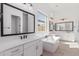 Contemporary bathroom featuring dual vanities, a soaking tub, a large window and modern fixtures at 5749 E Sanford St, Mesa, AZ 85215