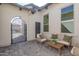 Cozy courtyard with neutral furniture and a charming iron gate, creating a relaxing outdoor space at 5749 E Sanford St, Mesa, AZ 85215