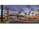 Elegant community entrance with mature palm trees, desert landscaping, and stone signage at 5749 E Sanford St, Mesa, AZ 85215