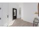Bright entryway featuring hardwood floors, white walls, and stylish modern lighting at 5749 E Sanford St, Mesa, AZ 85215