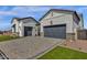 Beautiful home featuring a paver driveway and manicured lawn, adding to its curb appeal at 5749 E Sanford St, Mesa, AZ 85215