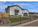Landscaped home exterior with dark metal fencing and desert landscaping at 5749 E Sanford St, Mesa, AZ 85215