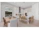 Bright kitchen with a brick accent wall, center island with barstool seating, and wood floors at 5749 E Sanford St, Mesa, AZ 85215