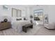 Calm, light-filled main bedroom with a decorative rug, an accent chair and light wood flooring at 5749 E Sanford St, Mesa, AZ 85215