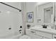 Bright bathroom with a white vanity, shower/tub combo, and neutral colored decor at 5756 E Star Valley St, Mesa, AZ 85215