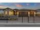 A home showcasing decorative stone accents and wrought iron fencing around a desert landscape at 5756 E Star Valley St, Mesa, AZ 85215