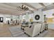 Open-concept living room with wood beam ceilings, neutral decor, and lots of natural light at 5756 E Star Valley St, Mesa, AZ 85215