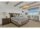 Serene main bedroom with a tufted headboard, wood-look flooring, and abundant natural light at 5756 E Star Valley St, Mesa, AZ 85215