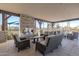 Covered patio with stone fireplace, comfortable seating, and view of the playground and community at 5756 E Star Valley St, Mesa, AZ 85215