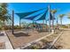Community playground shaded by blue sails and a climbing structure at 5756 E Star Valley St, Mesa, AZ 85215