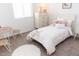 Cozy bedroom with a decorative pillow, plush carpet, and a charming round table at 5916 S Daisy Patch Pl, Phoenix, AZ 85040