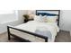 Comfortable bedroom features a plush bed, a decorative pillow, and a stylish end table at 5916 S Daisy Patch Pl, Phoenix, AZ 85040